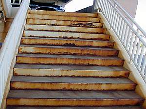 corroding staircase with rust bleeding
