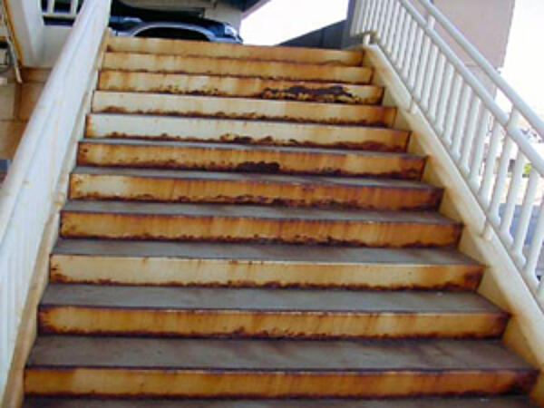 corroding staircase with rust bleeding