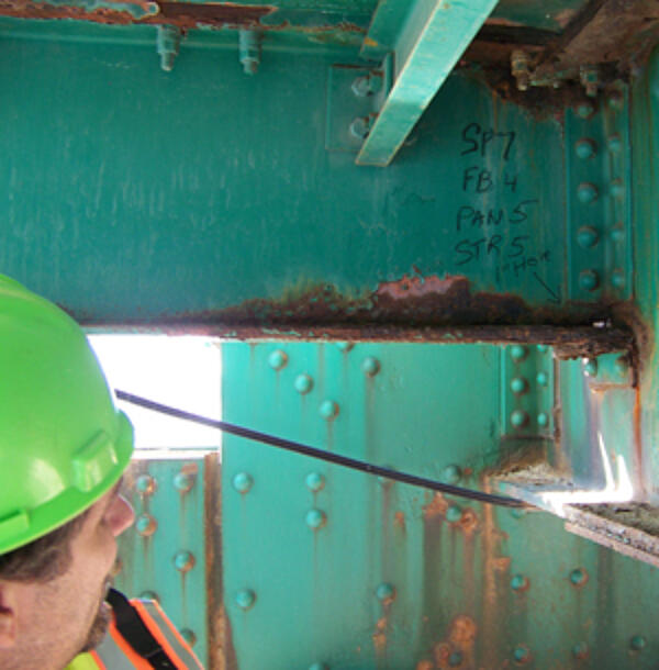 inspecting corrosion on a steel bridge