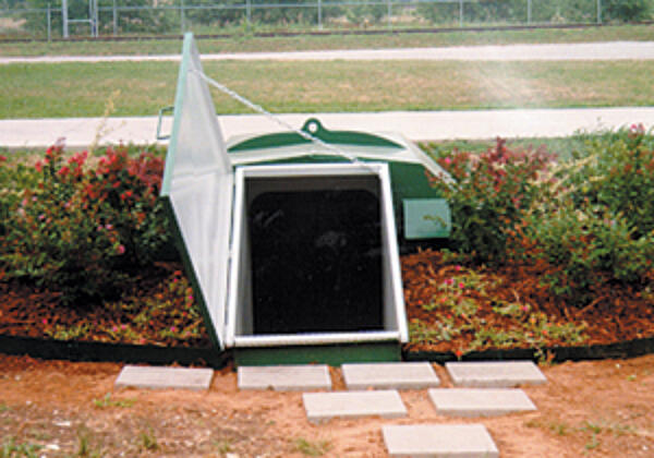 galvanized storm shelter buried in soil 