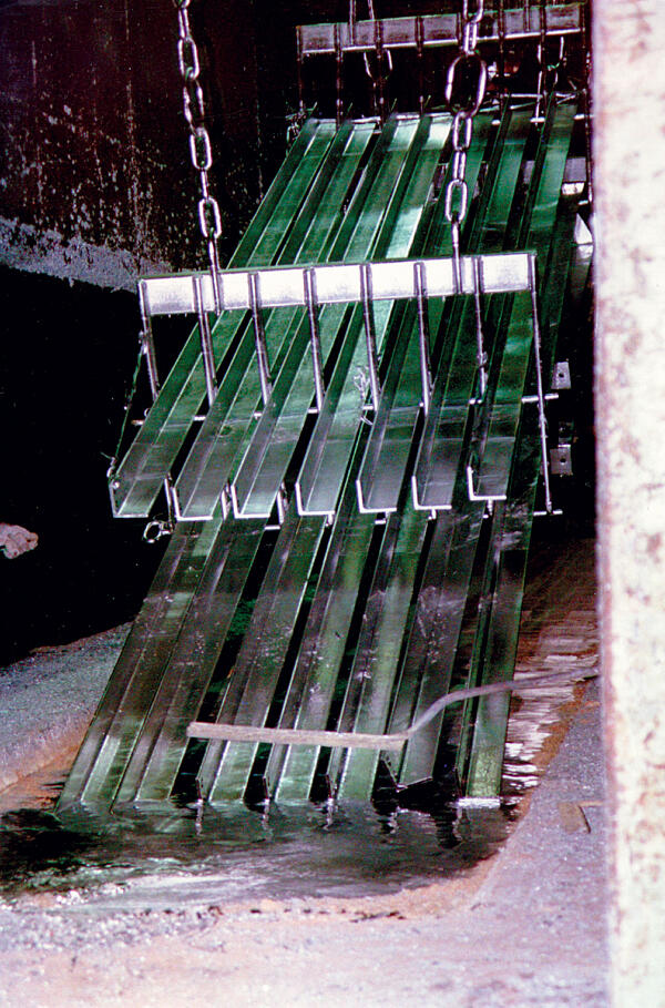 Steel articles being removed from the hot-dip galvanizing bath